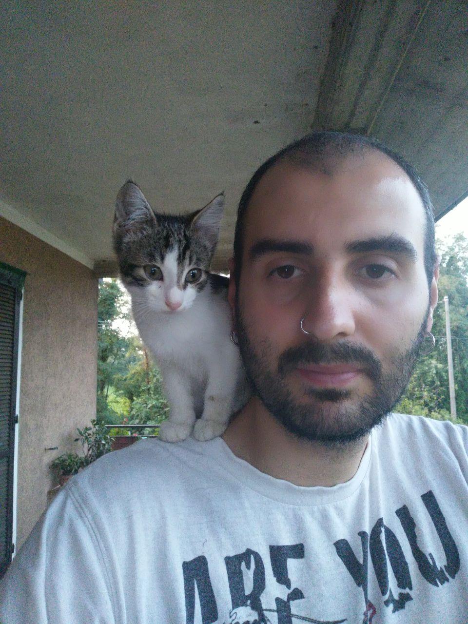 Sergio with a female cat on his shoulder, Mimma